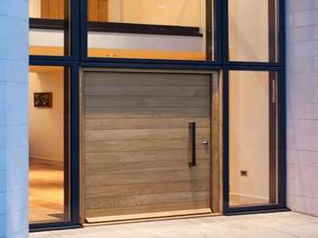 Installation of our Allstyle Curtian walling system TRIPLE Glazed center pane U value .65. Marine finish PP Coated Aluminium in Matt finish. Funky door in oak. four point hook locking working of a self locking pull shut handle
